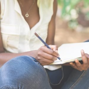 Woman writing in a notebook.